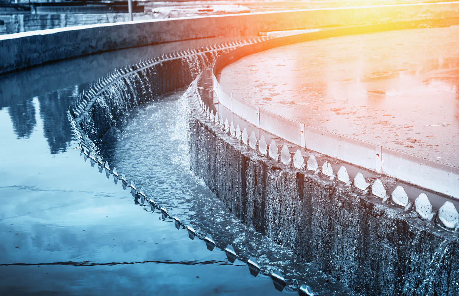Modern urban wastewater treatment plant, blue toned.