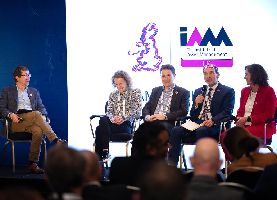 A group of people sitting in chairs in a room Description automatically generated