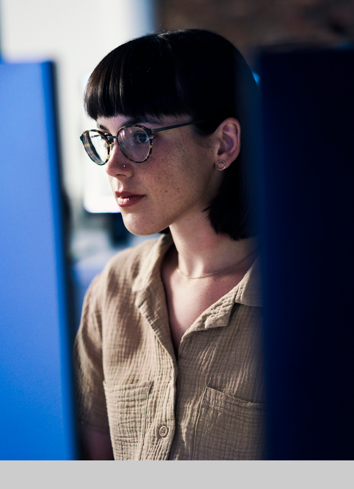 Concentrating, serious and night with woman and computer for software engineering, developer and designer. Cyber security, data science and code with employee in office for neon, website and html