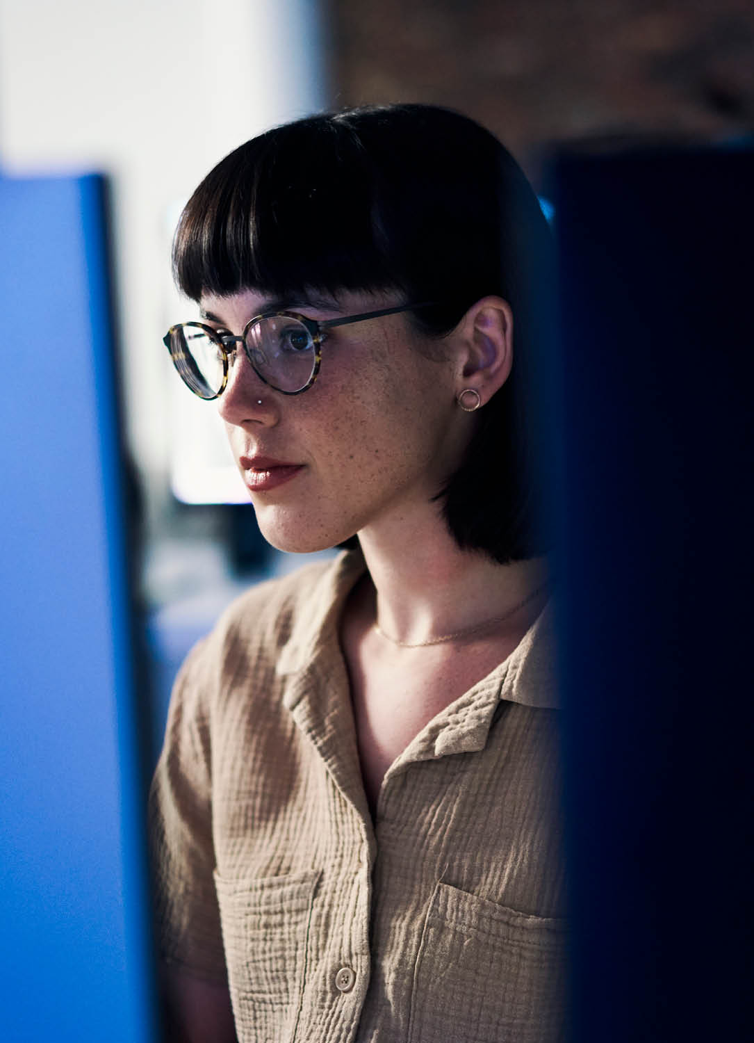 Concentrating, serious and night with woman and computer for software engineering, developer and designer. Cyber security, data science and code with employee in office for neon, website and html